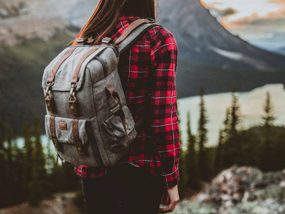 Traveller with a backpack looking at mountains
